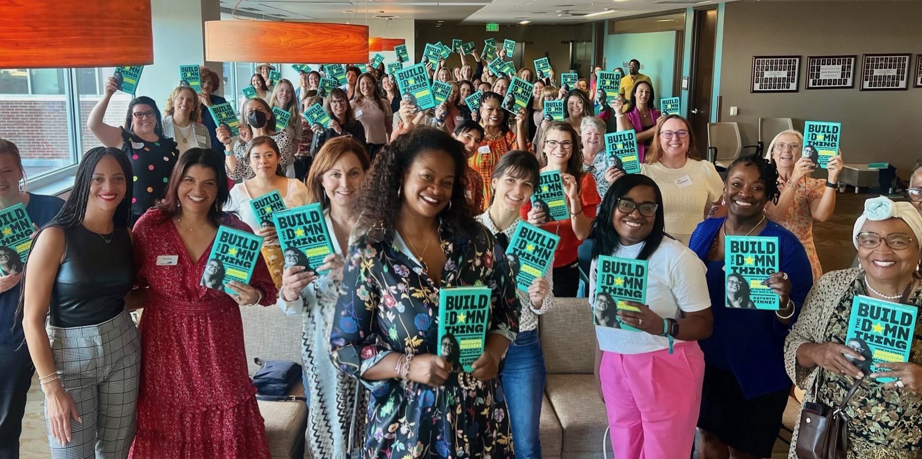 Readers holding Build the Damn Thing at a Kathryn Finney book event